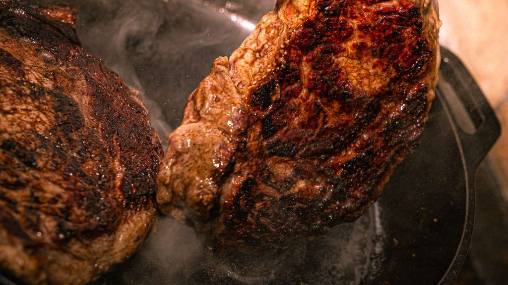 searing good marbling ribeye steak on cast iron